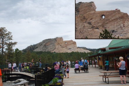 Photo of the Crazy Horse Memorial sculpture from the patio behind the museum/gift shop. Inset photo shows outline of horse's head which is the next stage of construction.